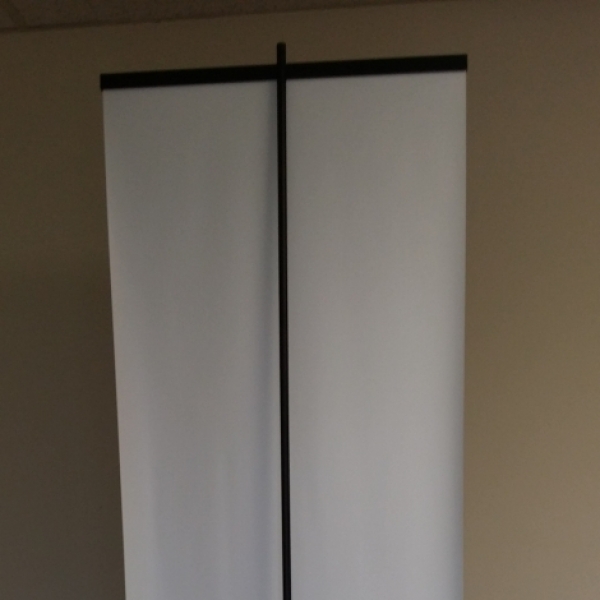 Back side of a retractable banner stand by Brooks Duplicator with a banner attached.
